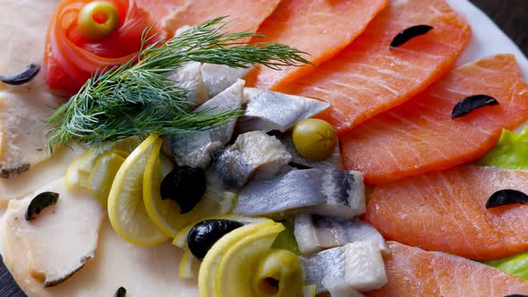 Seafood on Plate  Salmon Herring Fish and Sliced Fish Fillet Rotating alt