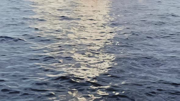 the Reflection of Sail of White Color on the Water Small Waves Blue Water in Motion alt