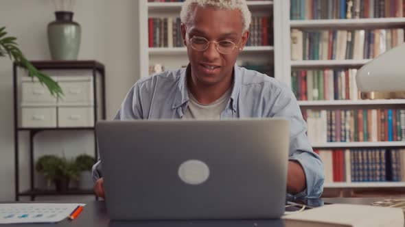 Close Up of Young African American Businessman Opening Laptop and Start Working alt