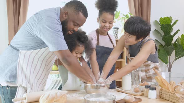 African America family wearing apron thresh flour for cooking bakery or bread together. alt