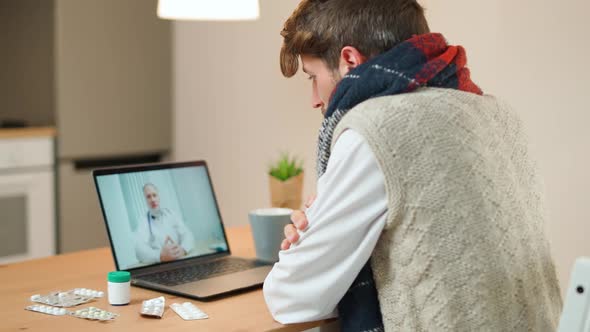 Man in Selfisolation Communicates with a Doctor By Video Call Using a Laptop a Patient Consults a alt