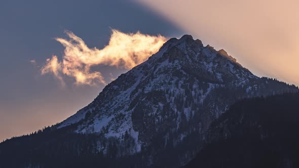 Fast Clouds Motion over Misty Alps Mountain Peak in Sunny Winter Evening Nature alt