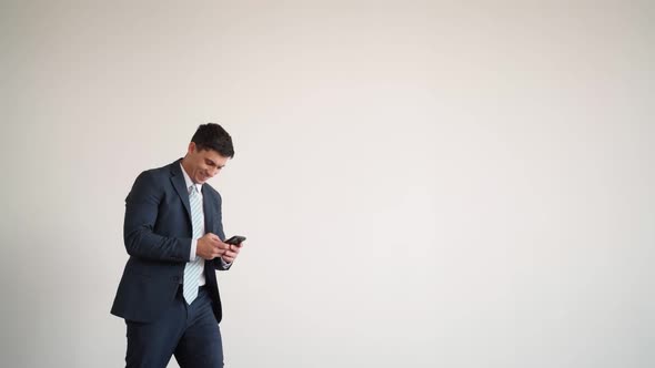 Businessman in Blue Jacket and Tie Texting on Phone Stumbles and Comically Falls alt