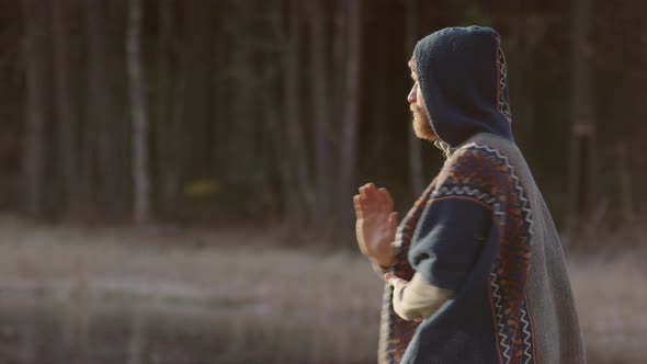 An ice bathing handsome bearded man warming up doing qigong tai chi before going in alt