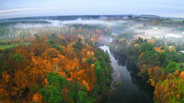 Foggy sunrise at the river in autumn, aerial view alt
