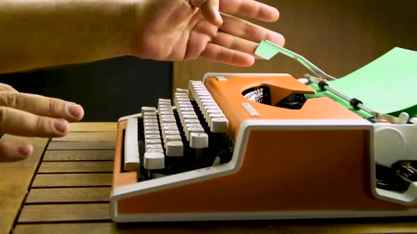 Man Hands Typing On A Vintage Typewriter Old Mechanical Orange White Green Paper