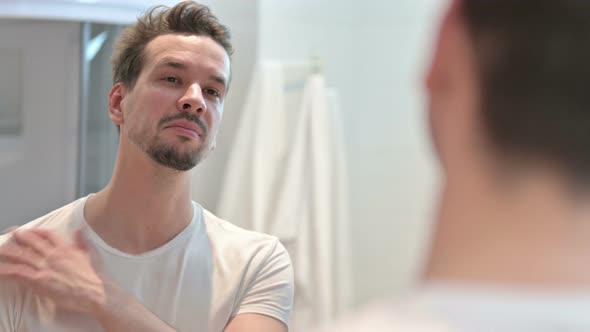 Confident Cheerful Young Man Smiling at Mirror  alt