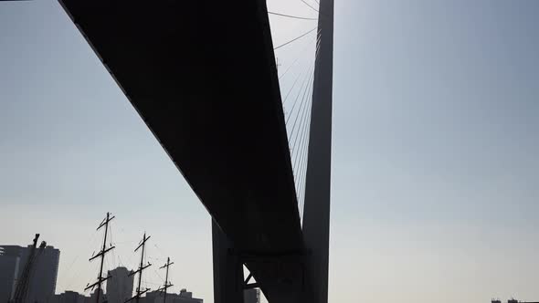 Bottom View of Huge Bridge in the Sun Against the Background of Urban New Buildings