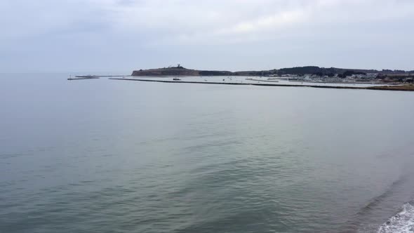 AERIAL: drone, shore, pillar point, and ships view, flying forward alt