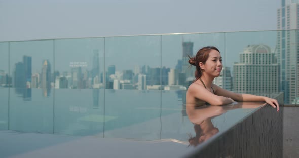 Woman Sit at The Infinity Swimming Pool