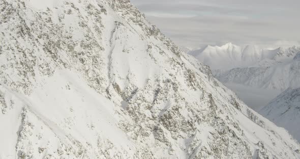 Aerial helicopter shot through fog of cold Alaskan forest, along road, drone footage alt