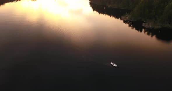 A fishing boat doing sunset shot from a drone. alt