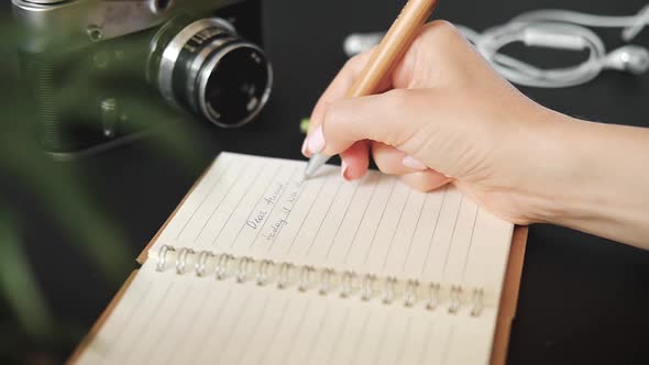 Close-up of the hands of a young unknown woman sitting at a table