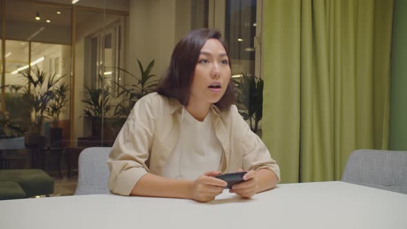 Pro Gamer Asian Woman Playing Online Game Indoors alt