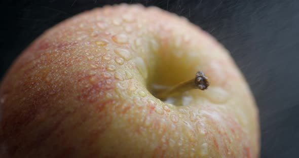 Apple rotating close-up / macro with water spray slowmotion 4k