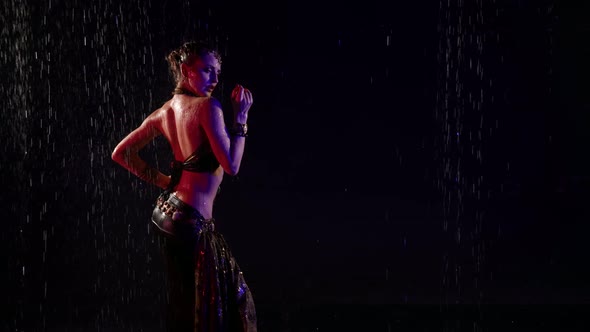 Figure of Exotic Oriental Dancer Woman in Darkness Under Rain Lady is Wearing Long Skirt alt