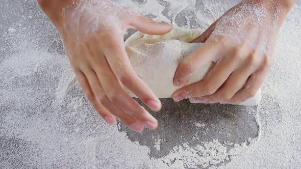 Woman kneading a dough alt