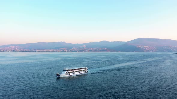 Ferry Boat Floating on Aegean Sea at Sunset Time alt