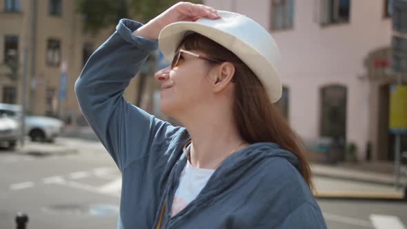Portrait of Pretty Traveler Woman in White Hat Looking Around Have Fun