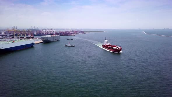 Aerial view of logistics concept cargo ship sailing out to the open sea leaving Laem Chabang dockyar alt
