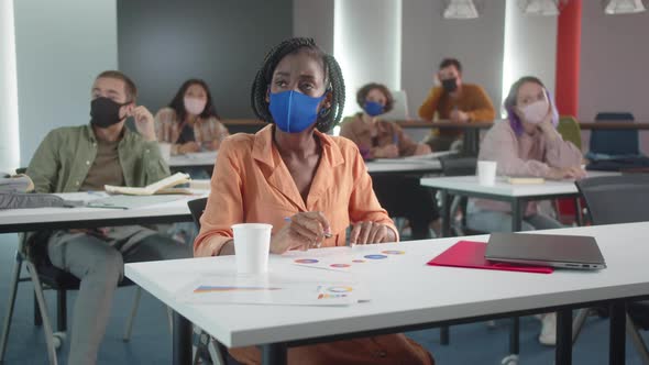 Sitting in the Classroom the Teacher is Listening Her Student's Work alt