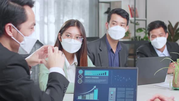 Asian Executive Explains Company's Vision And Potential To His Employees. They Are Wearing Face Mask alt
