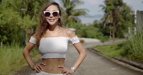 Cheerful Female Walking on Path in Tropical Country alt