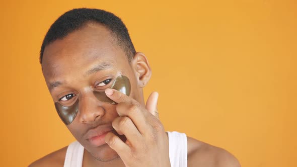 African American Wants Wellgroomed Skin Around the Eyes He Uses Collagen Patches Under the Eyes