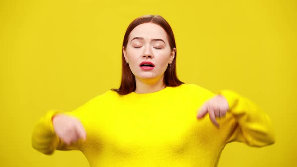 Stressed Young Redhead Woman Sighing and Closing Ears with Hands at Yellow Background alt