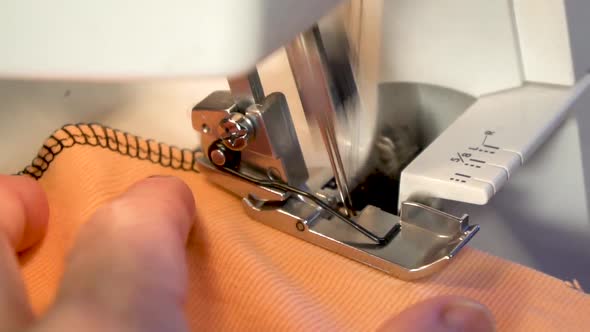 Women's hands sewing in slow motion