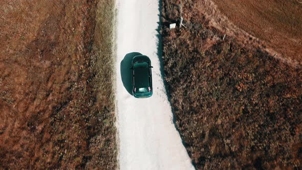 The car is moving on a sandy country road. Slow motion .