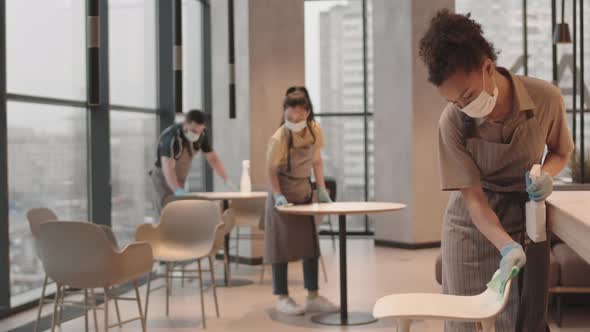 Employees Disinfecting Surfaces in Restaurant alt