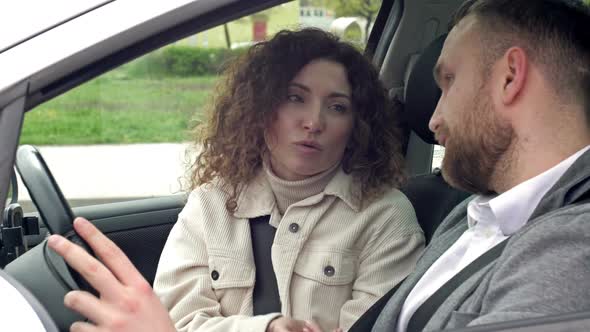 Man and Woman Emotionally Sort Things Out While Sitting in Their Car alt