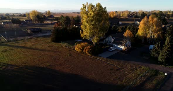 Drop drone shot near Fort Collins Colorado showing beautiful farm property alt