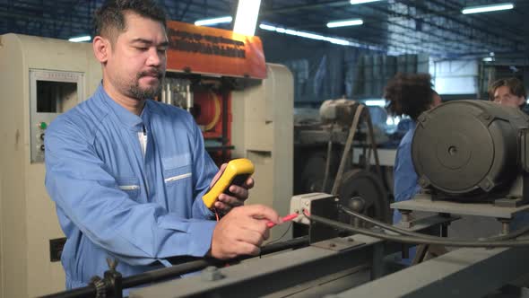 Engineer teams inspect machines' electric current at the industry factory. alt