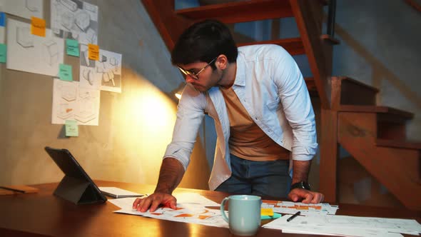 Businessman in casual Clothes checking and analyzing financial business paperwork in office at night alt