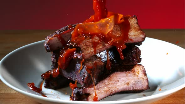 BBQ sauce pouring and splashing in ultra slow motion 1500fps onto BBQ ribs - BBQ PHANTOM  alt