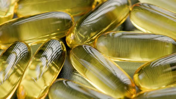 Golden Transparent Pills with Liquid Medicine Rotating Fullframe Closeup