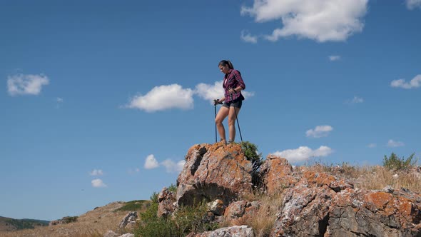 Happy Woman Climbs To Top Mountain And Raises His Arms Up Celebrating Success alt