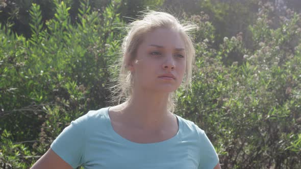A young woman runner resting after jogging. alt