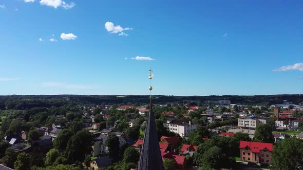  Holy Trinity Lutheran Church in Tukums, Latvia. Golden Cock Statue on the Top of Tower. 4K Video alt