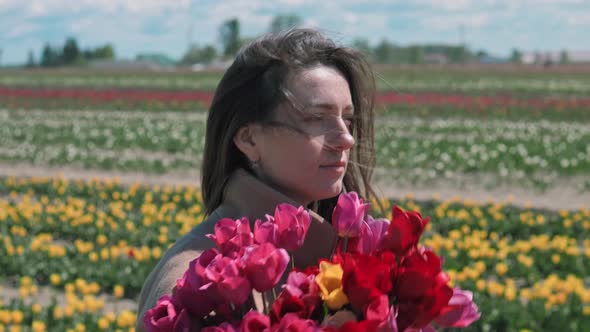 Woman walking with bouquet of tulips