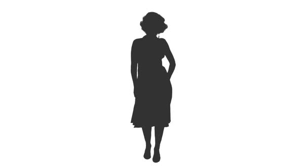 Silhouette of a Woman in Long Dress Dancing