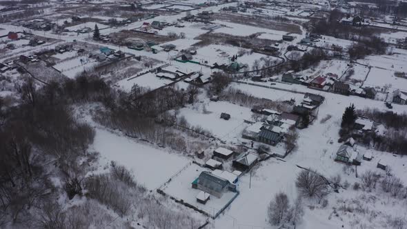 Old Wooden Houses in the Russian Village Covered with Snow