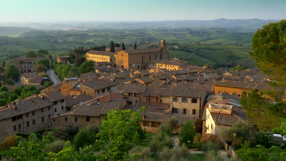 San Gimignano, Tuscany, Italy. Panning Shot of San Gimignano Medieval Town Roofs in Sunset Lights alt