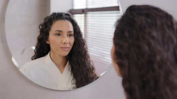 Closeup Serious Pensive Young Hispanic Woman Looking in Mirror in Bathroom Contemplating Future Cute alt