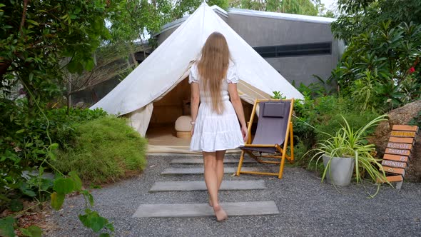 Young Beautiful Slim Woman in Short White Dress Walking Barefoot In Tourist Tent alt