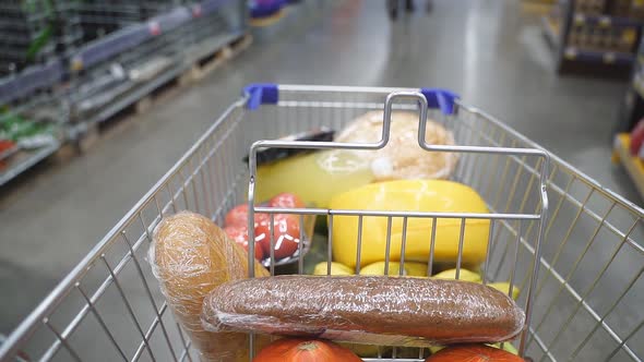 Shopping Cart Moving Between Various Section in Supermarket