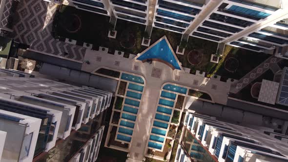 Cozy Residential Area with Park and Fountain Surrounded By Tall Buildings with Highraised Apartments alt