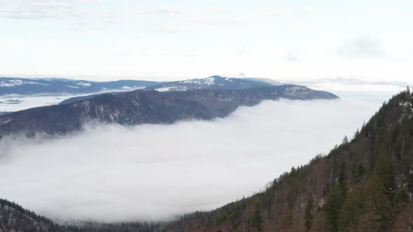 Aerial of beautiful valley seen above the clouds alt